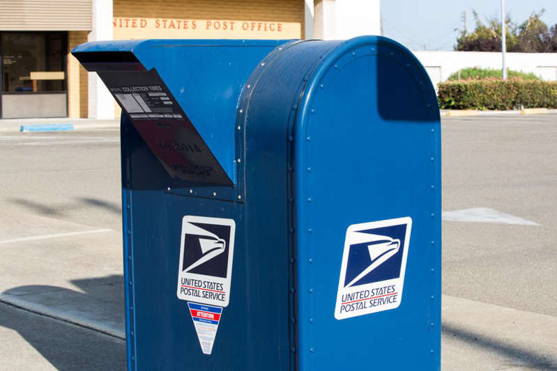 a parking meter sitting on the side of a road: Some of us still rely on a paper envelope and a stamp to send important documents or bills. Angela Lang/CNET